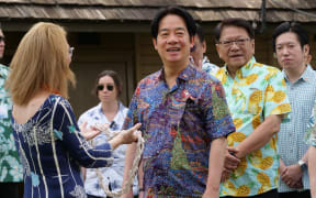 Bishop Museum director Dee Jay Mailer presents Taiwanese President Lai Ching-te with a rope lei during his visit to the museum in Honolulu, Hawaii, on November 30, 2024. - Taiwan President Lai Ching-te arrived Saturday in the United States for the start of a week-long tour in the Pacific that he said would usher in a new era of democracy, but has sparked fury in Beijing. (Photo by Ronen ZILBERMAN / AFP)