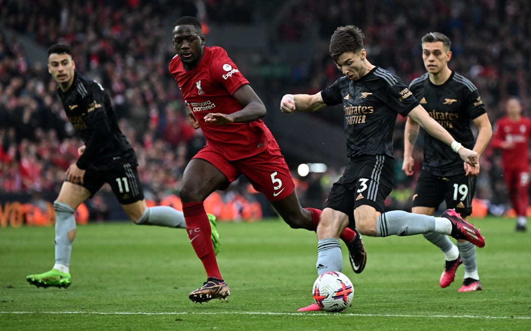 Arsenal's Scottish defender Kieran Tierney (2R) shoots wide of the goal during the English Premier League football match between Liverpool and Arsenal at Anfield in Liverpool, north west England on April 9, 2023. (Photo by Paul ELLIS / AFP) / RESTRICTED TO EDITORIAL USE. No use with unauthorized audio, video, data, fixture lists, club/league logos or 'live' services. Online in-match use limited to 120 images. An additional 40 images may be used in extra time. No video emulation. Social media in-match use limited to 120 images. An additional 40 images may be used in extra time. No use in betting publications, games or single club/league/player publications. /