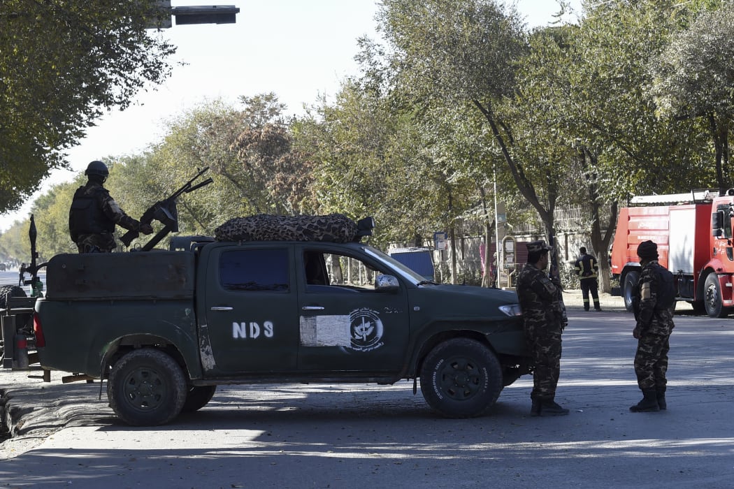 Security personnel stand guard outside Kabul University on November 2, 2020 after gunmen stormed the university.