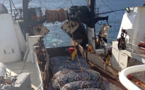 A Sealord fishing boat at sea.