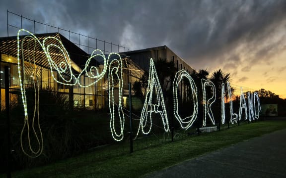 A luminous Māoriland sign outside Ngā Purapura in Ōtaki