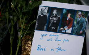 A message of tribute for Britain's Prince Philip is seen amid flowers outside Buckingham Palace in London, United Kingdom on April 09, 2021.