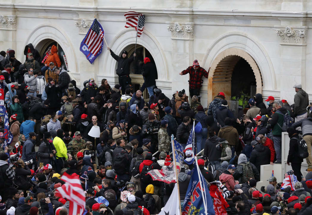 Supporters of US President Donald Trump storm the US Capitol during a rally to contest the certification of the 2020 US presidential election results.