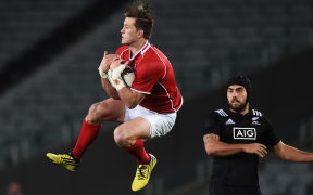 The Maori All Blacks captain Charlie Ngatai looks on as Cory Jane secures the high ball.