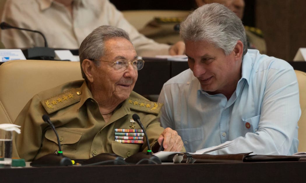 Raul Castro (L) talks with Miguel Diaz-Canel during the First Annual Session of the Cuban Parliament at the Convention Palace in Havana.