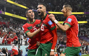 Morocco's forward #19 Youssef En-Nesyri (C) celebrates with  teammates after scoring the opening goal during the Qatar 2022 World Cup quarter-final football match between Morocco and Portugal at the Al-Thumama Stadium in Doha on December 10, 2022.