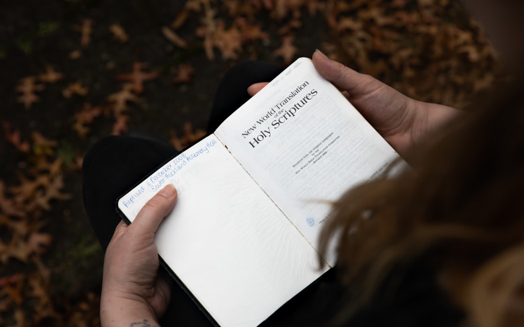 Cassie Dean leafs through the pages of her childihood bible, the New World Translation of the Holy Scriptures.