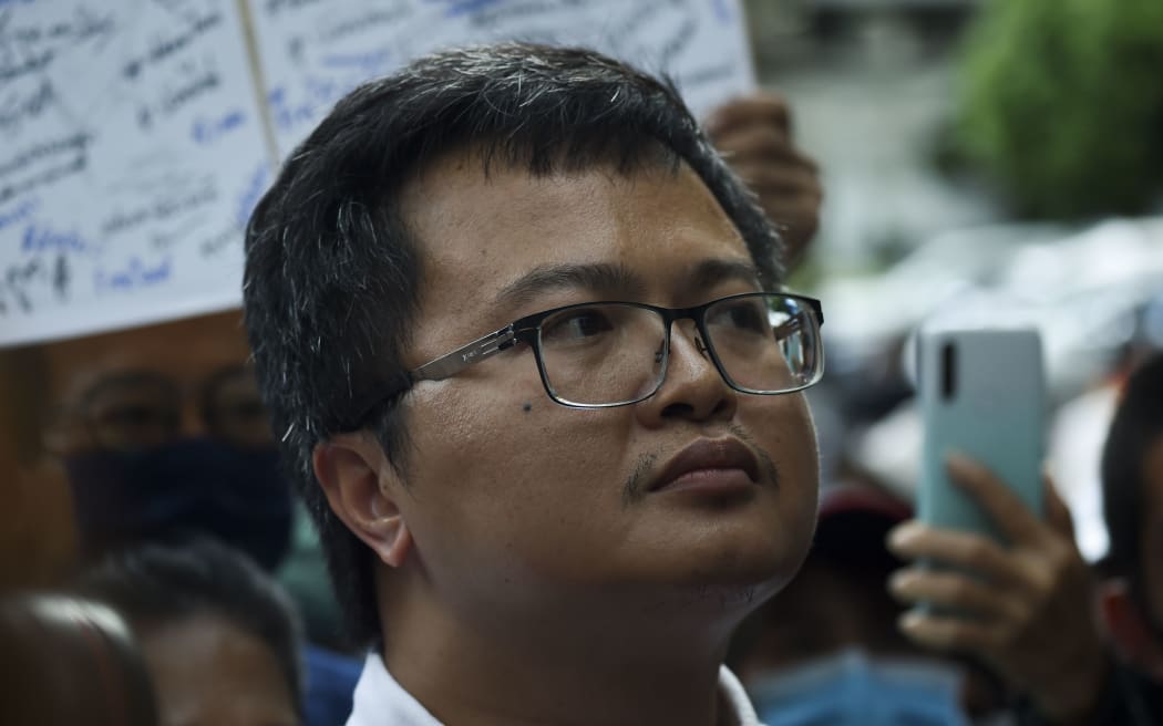Thai lawyer and pro-democracy activist Anon Nampa (C) is seen after the court allowed temporary release at the Criminal Court in Bangkok, Thailand, 08 August 2020.