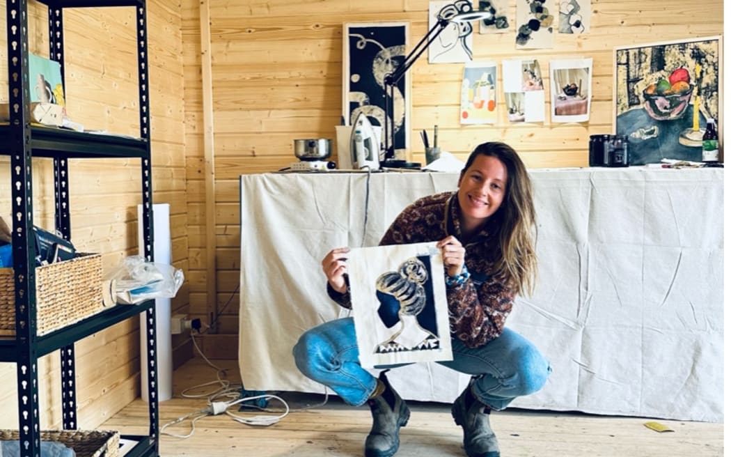 Cate King in her art studio. She uses beeswax from her honey business to make batik-style artwork.