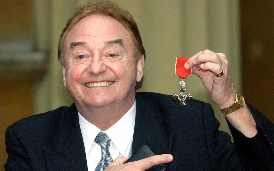 Sixties singing sensation Gerry Marsden, from Liverpool, poses with his MBE for services to Liverpudlian Charities at Buckingham Palace in London.