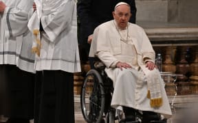 Pope Francis, seated in a wheelchair, leaves after leading the Easter Vigil mass on 8 April, 2023 at St. Peter's basilica in The Vatican, as part of celebrations of the Holy Week.