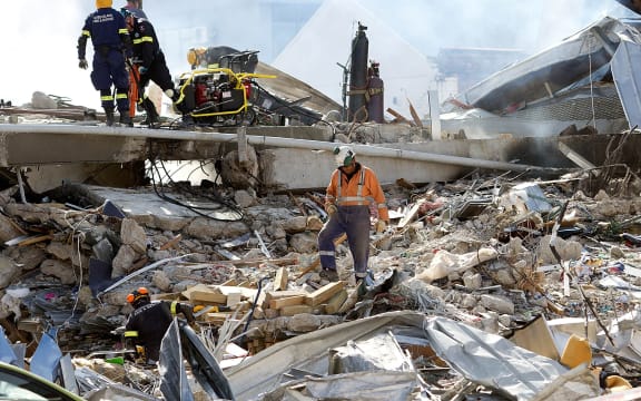 Rescuers work in the ruins of the collapsed CTV building