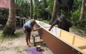 A final touch of paint is given to one of the canoes being built as part of the Uto ni Yalo Trust project in Fiji