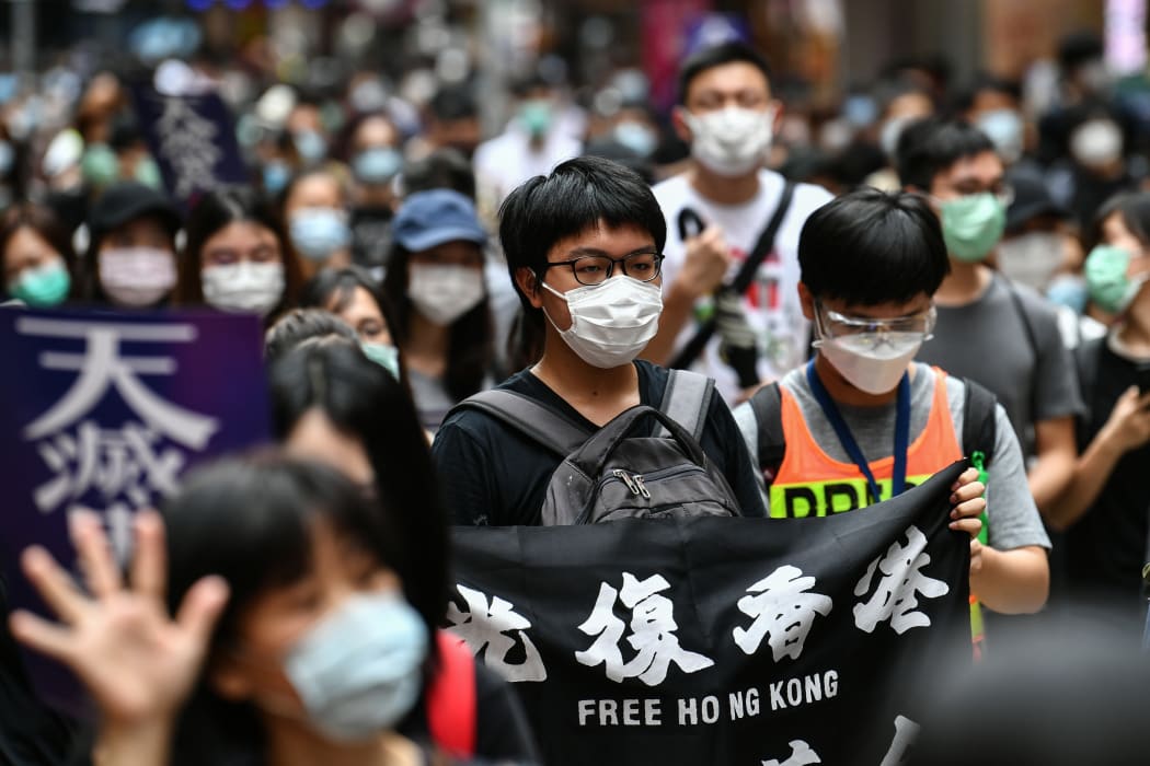 Protesters march on a road during a pro-democracy rally against a proposed new security law