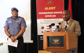 Papua New Guinea's Prime Minister James Marape (right) updates media on the countries covid-19 response, alongside the Emergency Controller, Police Commissioner David Manning.