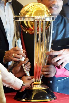 Indian fans look at the 2015 ICC Cricket World Cup trophy on display in Kolkata.