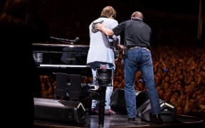 Elton John leaves the stage after ending his show early.