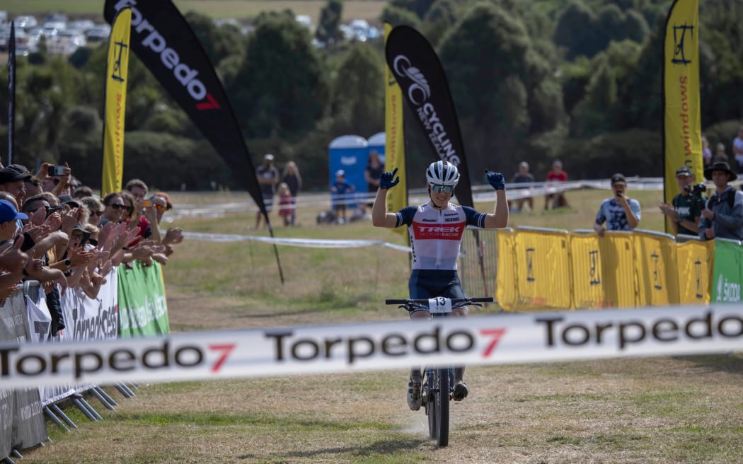 Anton Cooper celebrates winning the men's elite national title for the seventh time at the New Zealand Mountain Biking Cross Country Championship held at the Crocodile Mountain Bike Park in Christchurch.