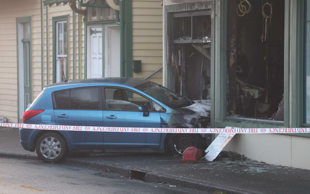 A car has crashed into a building in Mt Eden and then caught fire in the early hours of Tuesday morning.