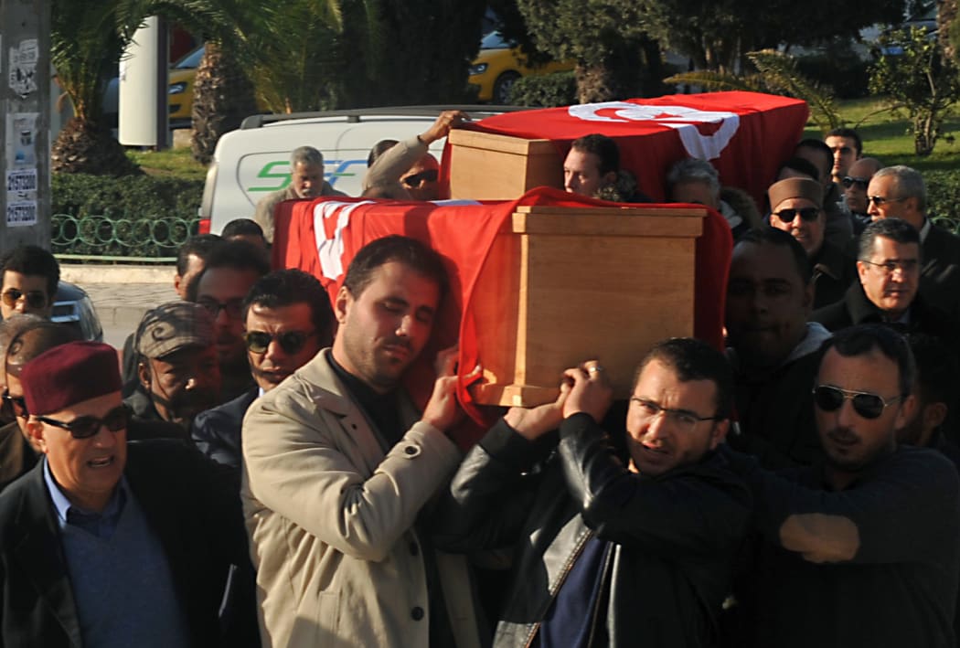 Relatives and friends carry the coffins of husband and wife Mohamed Azzabi and Senda Nakaa who were victims of the Istanbul nightclub shooting on New Year's Eve, during their funeral at a cemetary in La Marsa, near the capital Tunis, on January 3, 2017.