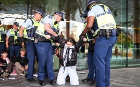 Several protesters have been carried away by police outside the national aerospace summit in Christchurch.