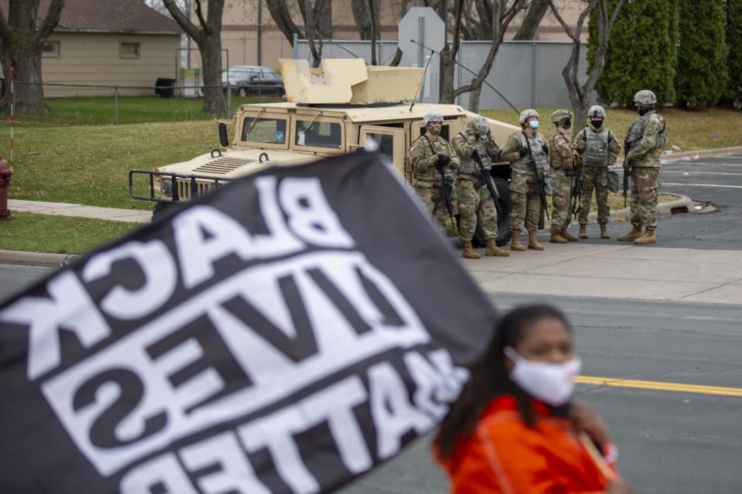 Minnesota National Guard and law enforcement members stand guard outside the Brooklyn Center Police Station after a police officer shot and killed a Black man in Brooklyn Center, Minneapolis, Minnesota on April 12, 2021.