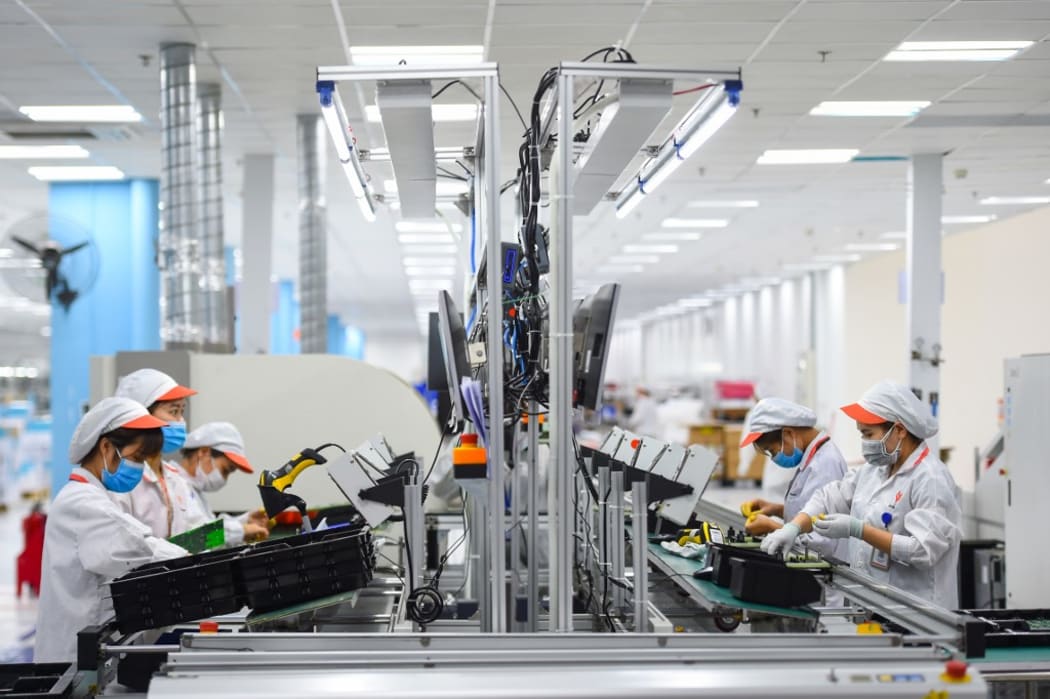 Workers assemble medical ventilators, which will be used by COVID-19 novel coronavirus patients, at a Vingroup production facility in Hanoi on August 3, 2020. (Photo by Nhac NGUYEN / AFP)
