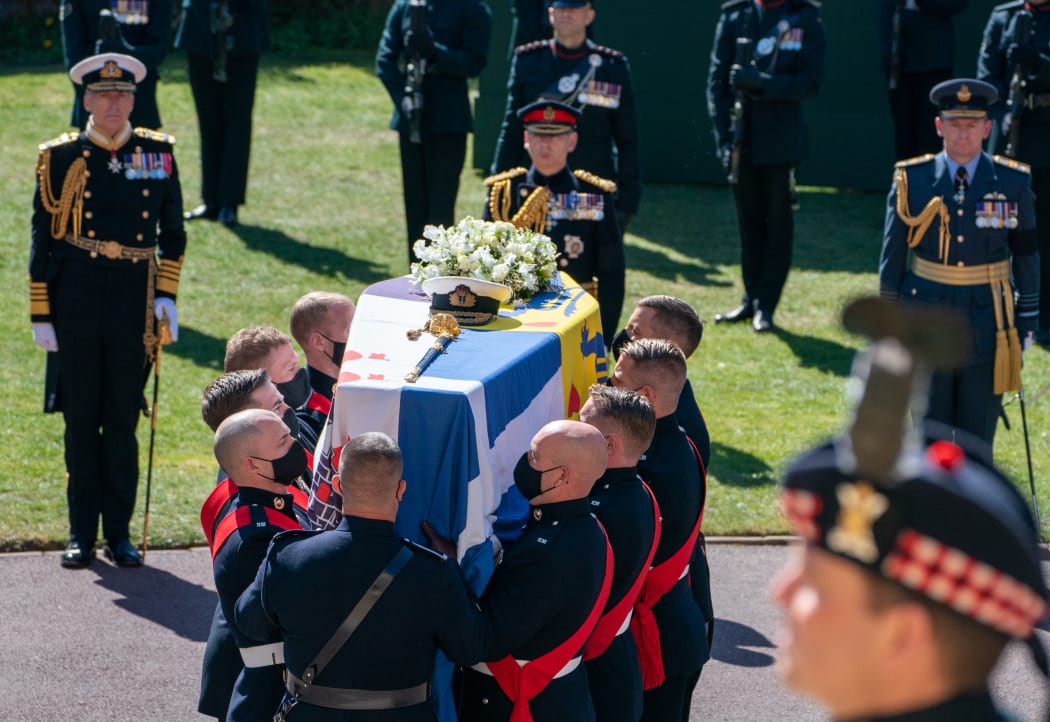 Pallbearers of the Royal Marines carry the coffin into St George's Chapel for the funeral service of Britain's Prince Philip, Duke of Edinburgh in Windsor Castle in Windsor, west of London, on April 17, 2021.