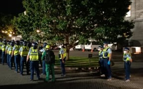 Police with shields prepare for an operation at Parliament.