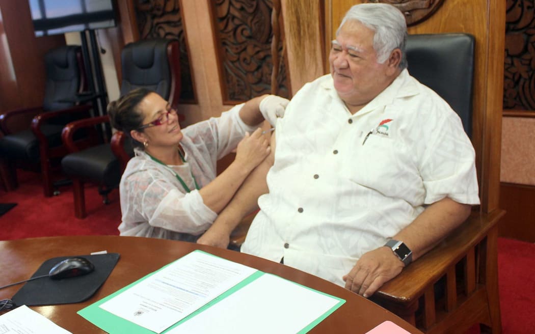 Samoa's Prime Minister Tuilaepa Sailele Malielegaoi receives his measles vaccination.