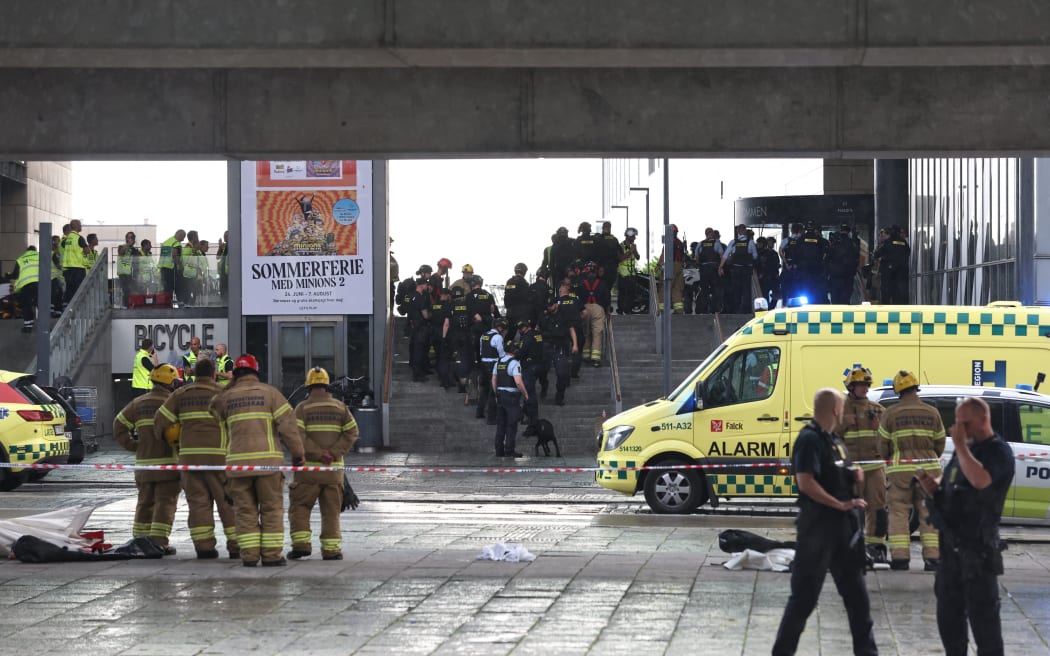 Police officers and rescuers are seen in front of the Fields shopping center in Oerested in Copenhagen, on July 3, 2022, after a shooting took place in the shopping center. - Gunfire in a Copenhagen mall on July 3, 2022 left several dead and several wounded, Danish police said, adding they had arrested one person in his twenties. (Photo by Olafur Steinar Gestsson / Ritzau Scanpix / AFP) / Denmark OUT
