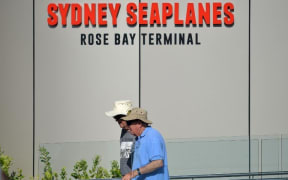 Visitors are seen at the entrance to the Sydney Seaplanes terminal in Rose Bay, Sydney on January 1, 2018.