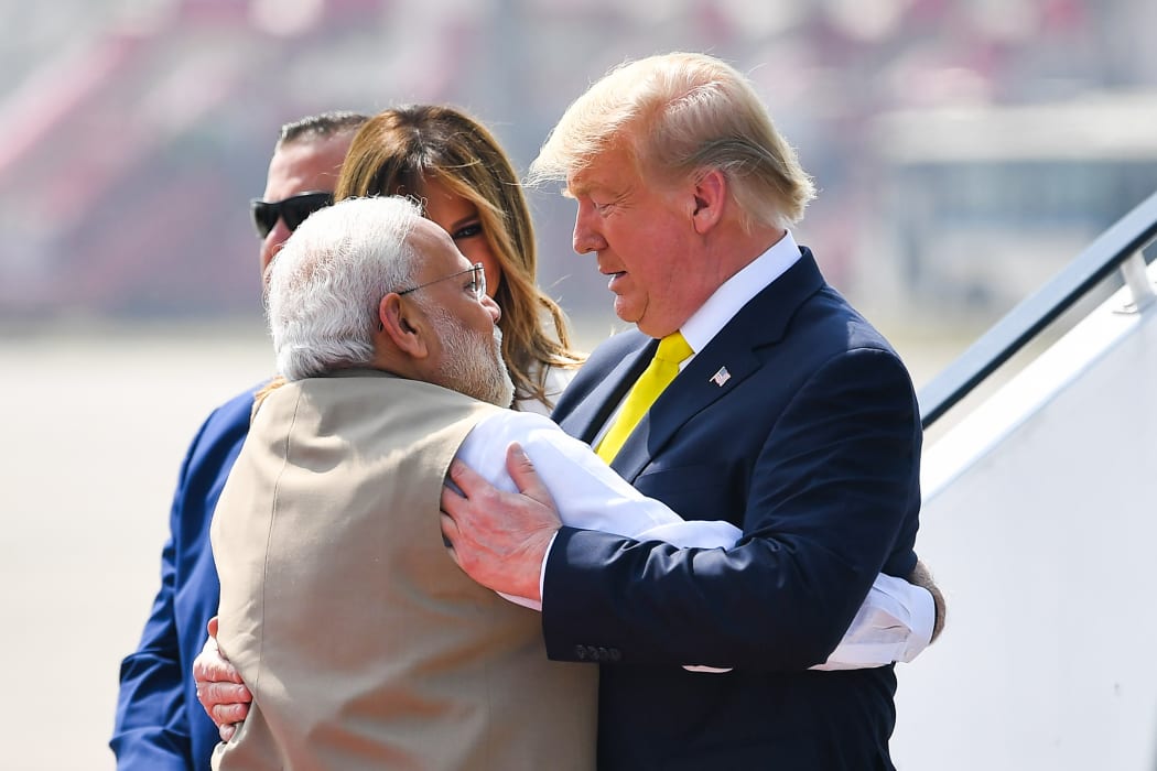 India's Prime Minister Narendra Modi (left) embraces US President Donald Trump upon his arrival at Sardar Vallabhbhai Patel International Airport on 24 February, 2020.
