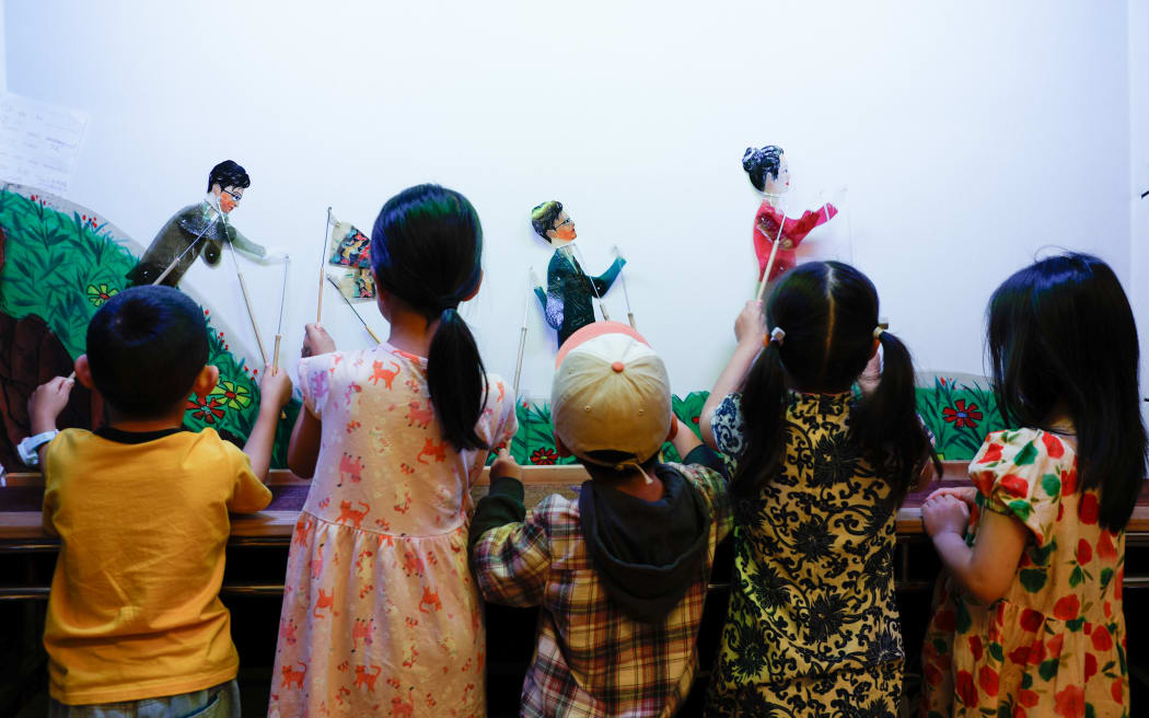Young children participate in a Chinese shadow puppetry workshop ahead of Lunar New Year celebrations.