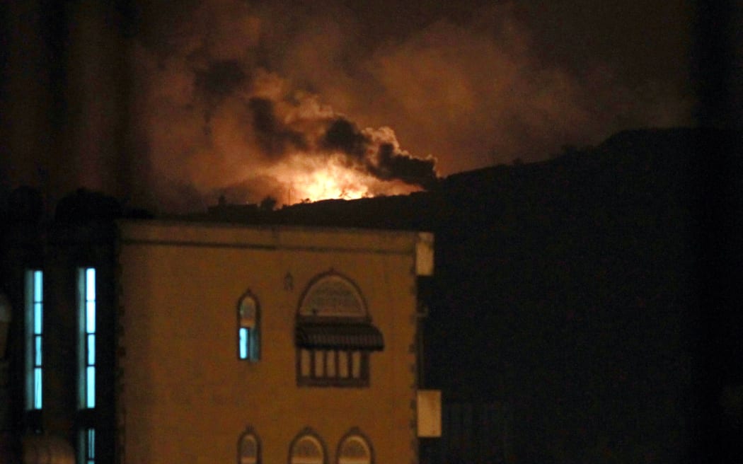 Smoke and flames rise from an alleged weapons storage depot at a Shiite Huthi rebel camp after the airstrike.