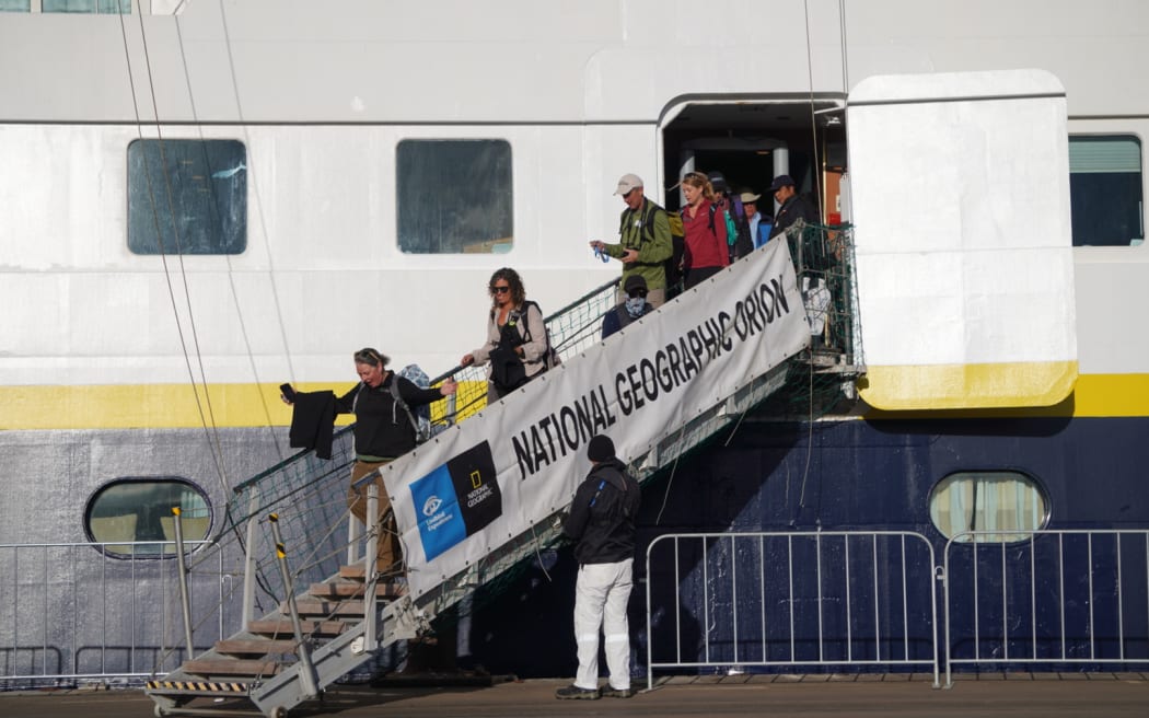 Passengers and crew disembark.
