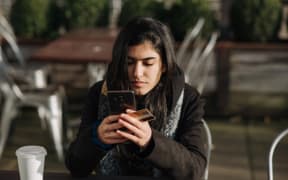 woman on phone with credit card