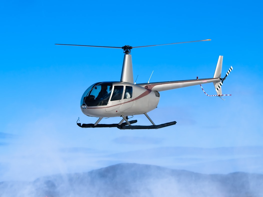 Helicopter flying. Robinson R22 file image.