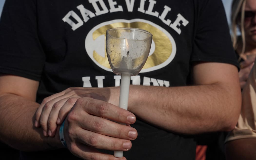 A mourner attends a vigil at the First Baptist Church of Dadeville, Alabama, following a mass shooting during a birthday party at the Mahogany Masterpiece dance studio in the city on 15 April, 2023, which left four people dead and 28 injured.