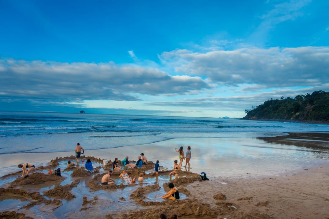 Tourists digging their own hot springs in Hot Water Beach, Coromandel, in 2017.