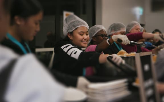 Members of the Life Church soup kitchen group serve dinner in South Auckland