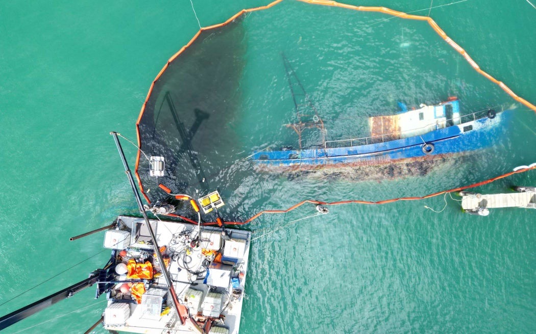 A skimmer cleans spilled oil from Carey Bay in Port Chalmers.