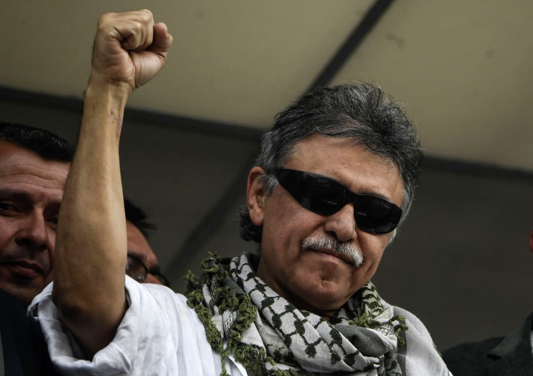 Jesus Santrich raises his clenched fist as he greets supporters after being released at the Farc headquarters in Bogota in 2019.