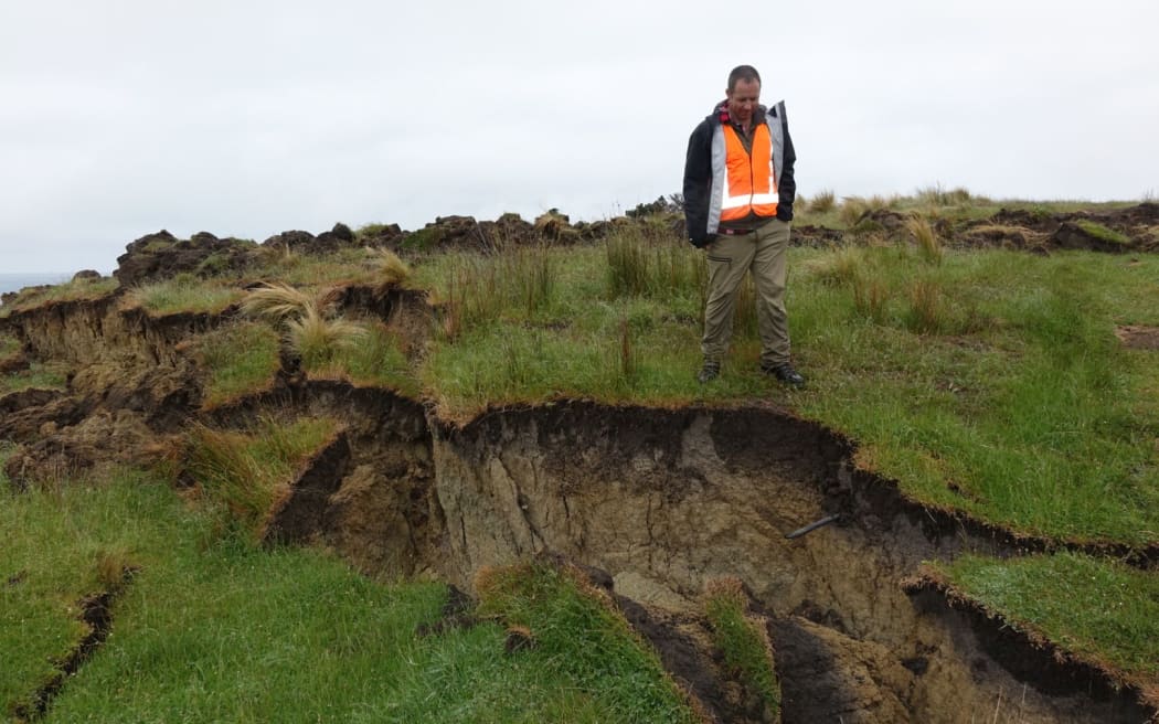 Adrian Benson inspects a land slump.