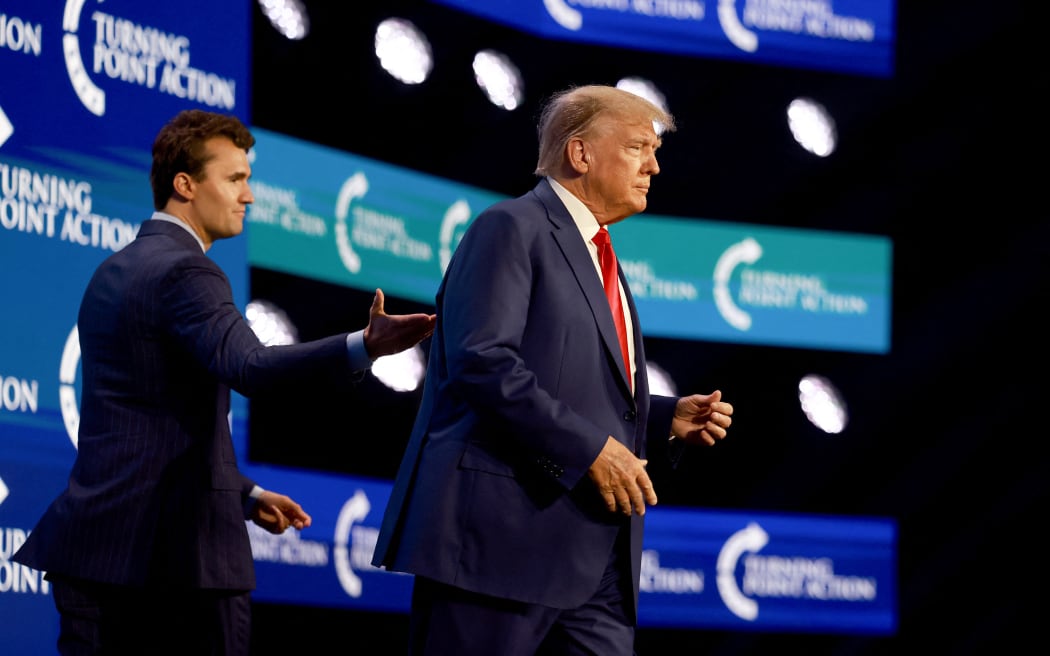 (FILES) Former US President Donald Trump walks on stage after being introduced by Charlie Kirk (L) at the Turning Point Action conference as he continues his 2024 presidential campaign on July 15, 2023 in West Palm Beach, Florida. Right-wing youth activist and influencer Charlie Kirk, a major ally of President Donald Trump, was shot dead on September 10, 2025 10, 2025 in an apparent assassination that sparked fears of more political violence in an increasingly febrile United States. Trump confirmed on social media that Kirk, 31, had died from his injuries. (Photo by JOE RAEDLE / GETTY IMAGES NORTH AMERICA / AFP)