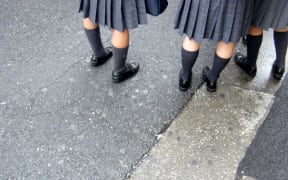 School girls in uniform, with socks.