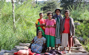 Evelyn Kunda surrounded by her family