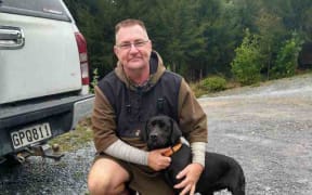 Dog-tracker Don Schwass with his own dog Piper.