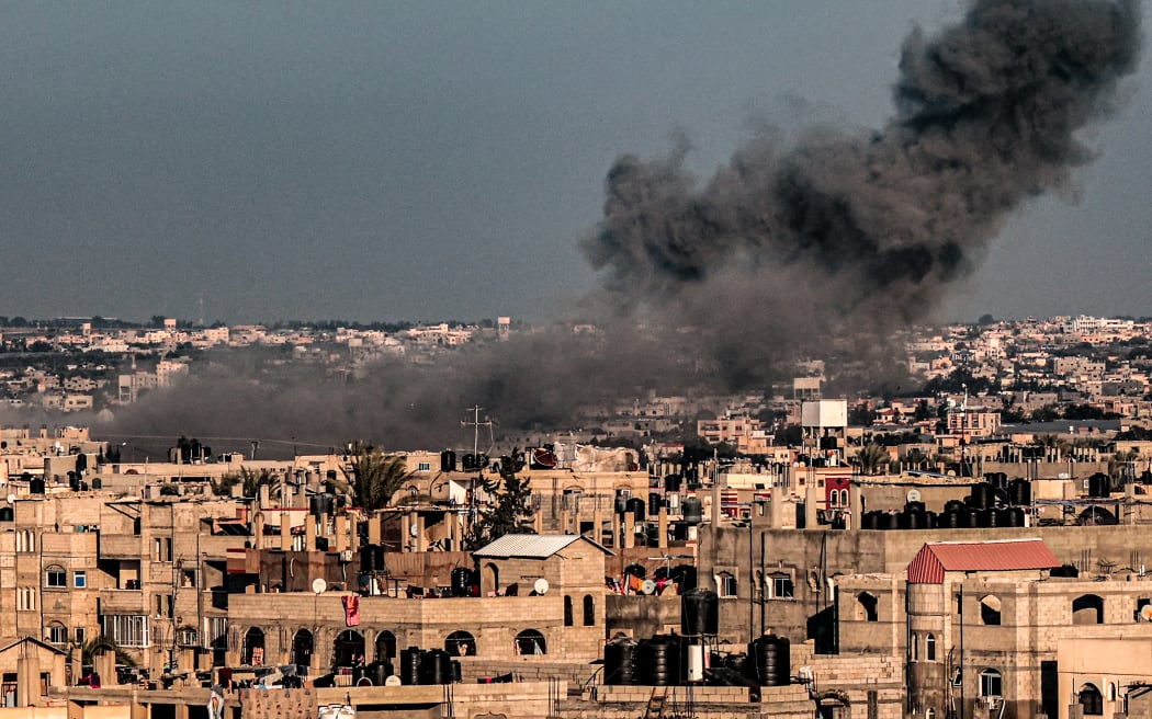 A smoke plume erupts over Rafah in the southern Gaza Strip, during Israeli bombardment on 11 February, 2024.
