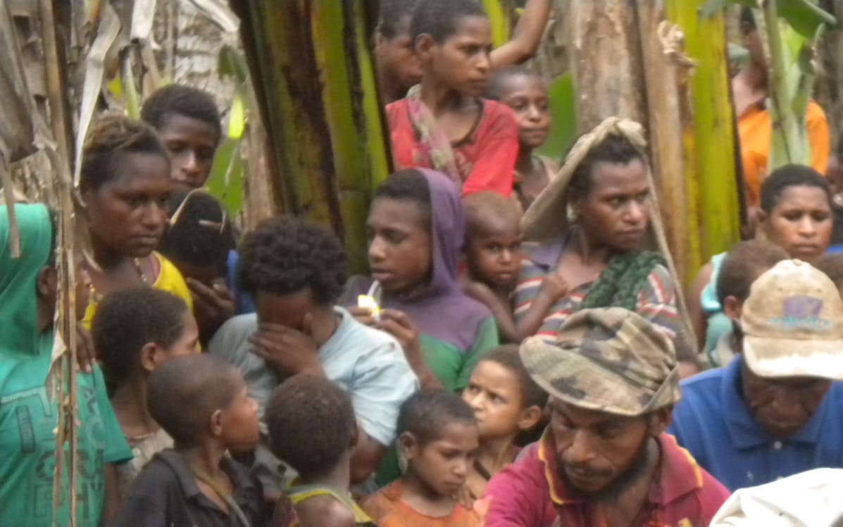 A husband and father is carried to his grave after dying in the bush when he went to make sago. He was hungry and weak and trying to feed his family.